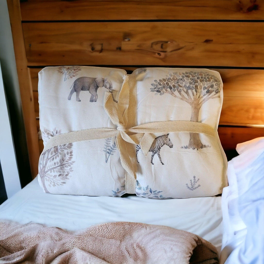 Precious Days Gifts large minky dot fleece baby blanket with elephant, zebra, and tree print, tied with ribbon.