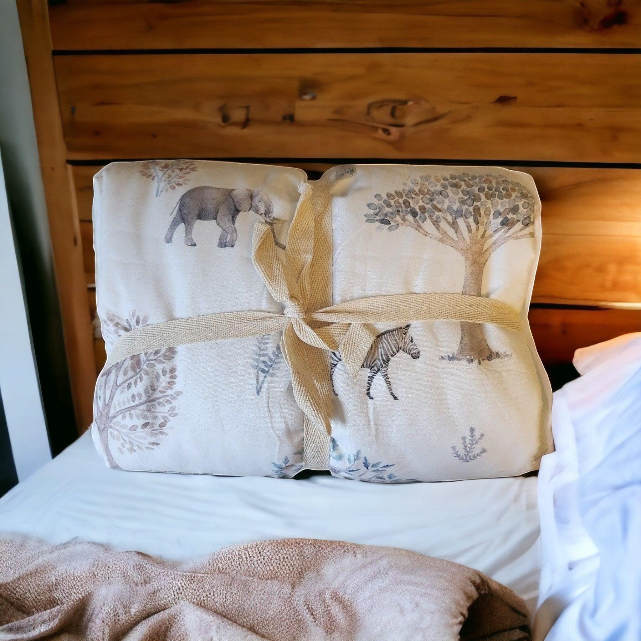 Precious Days Gifts large minky dot fleece baby blanket with elephant, zebra, and tree print, tied with ribbon.