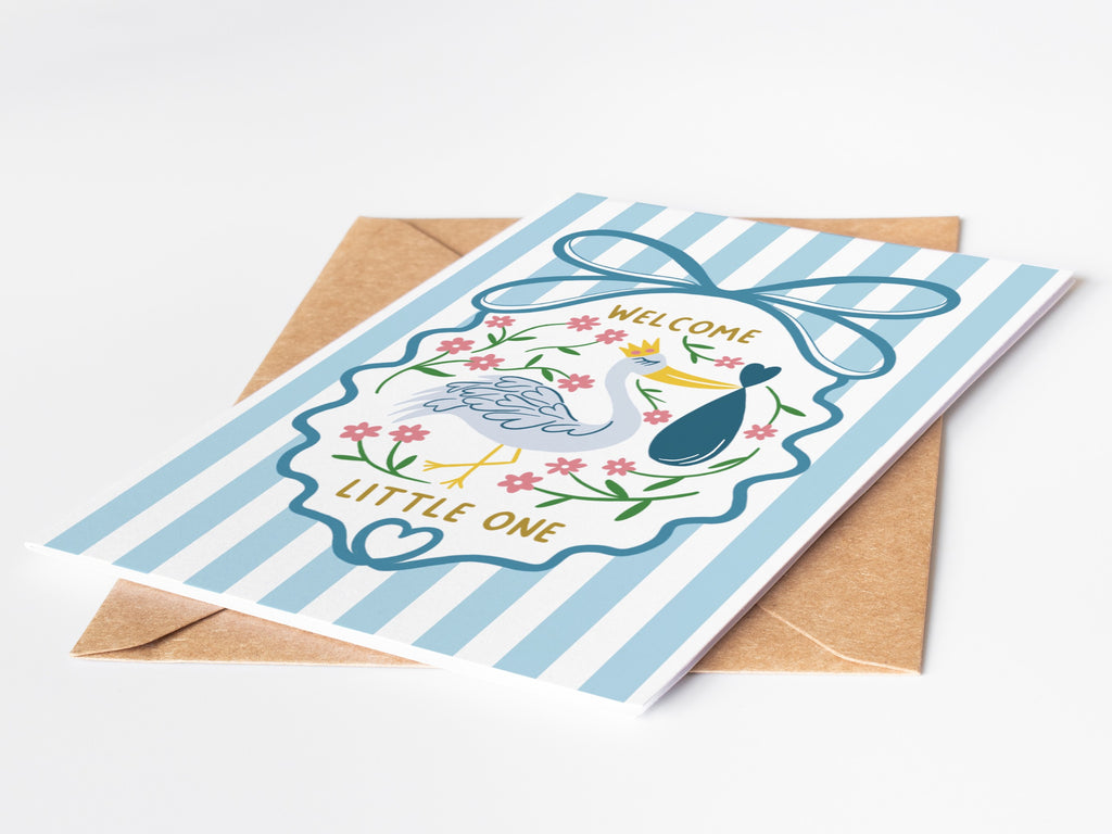 Precious Days Gifts blue striped baby card with stork carrying baby bundle, floral accents, and gold lettering.
