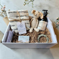 Precious Days Gifts large baby gift box with a cream bunny rattle, 'you are my sunshine' muslin, grey teether, and natural skincare.