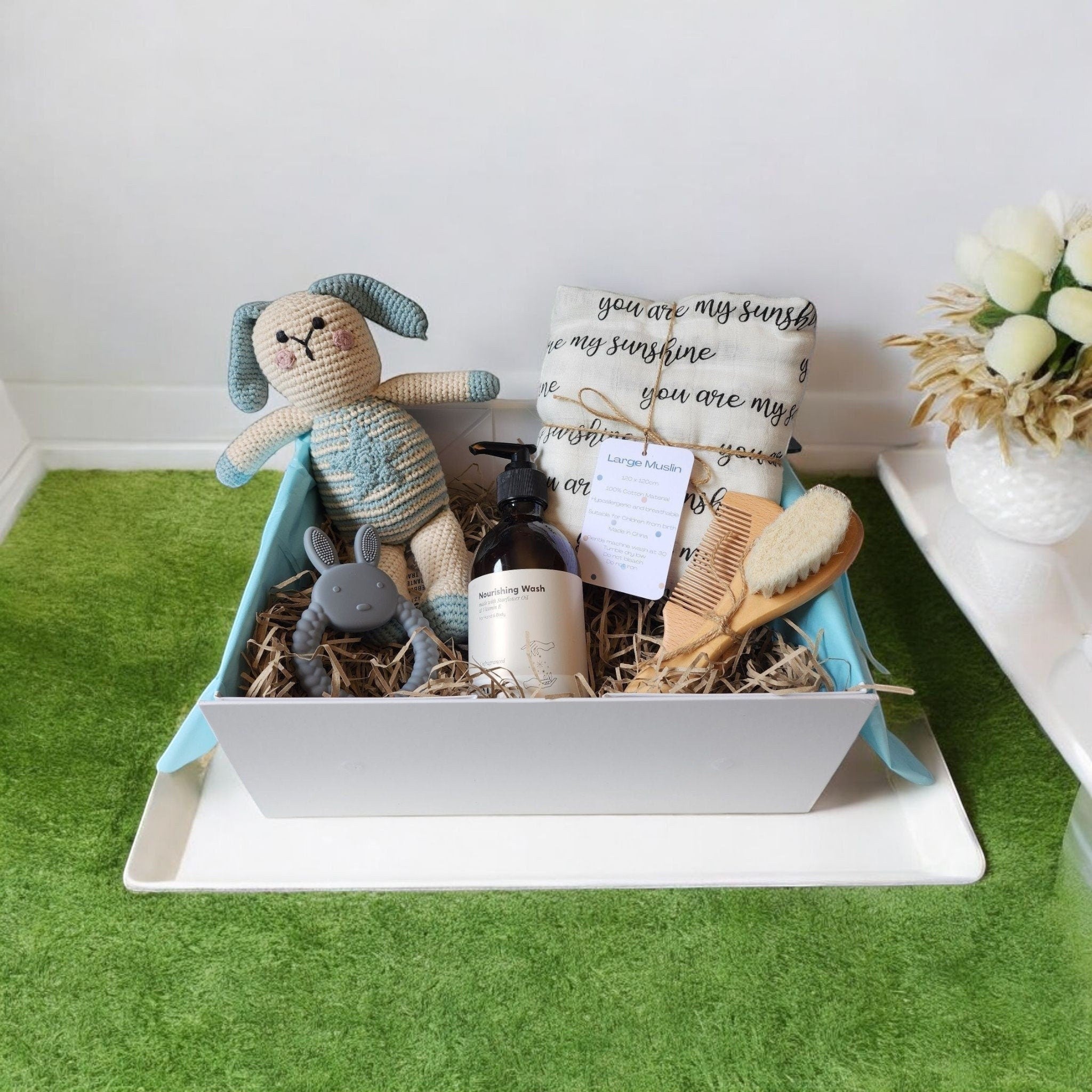 Precious Days Gifts new baby gift box with a crocheted bunny toy, muslin, teether, wash, and bamboo brush set.