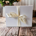 Precious Days Gifts white gift box with cream ribbon bow, perfect for new baby gifts.
