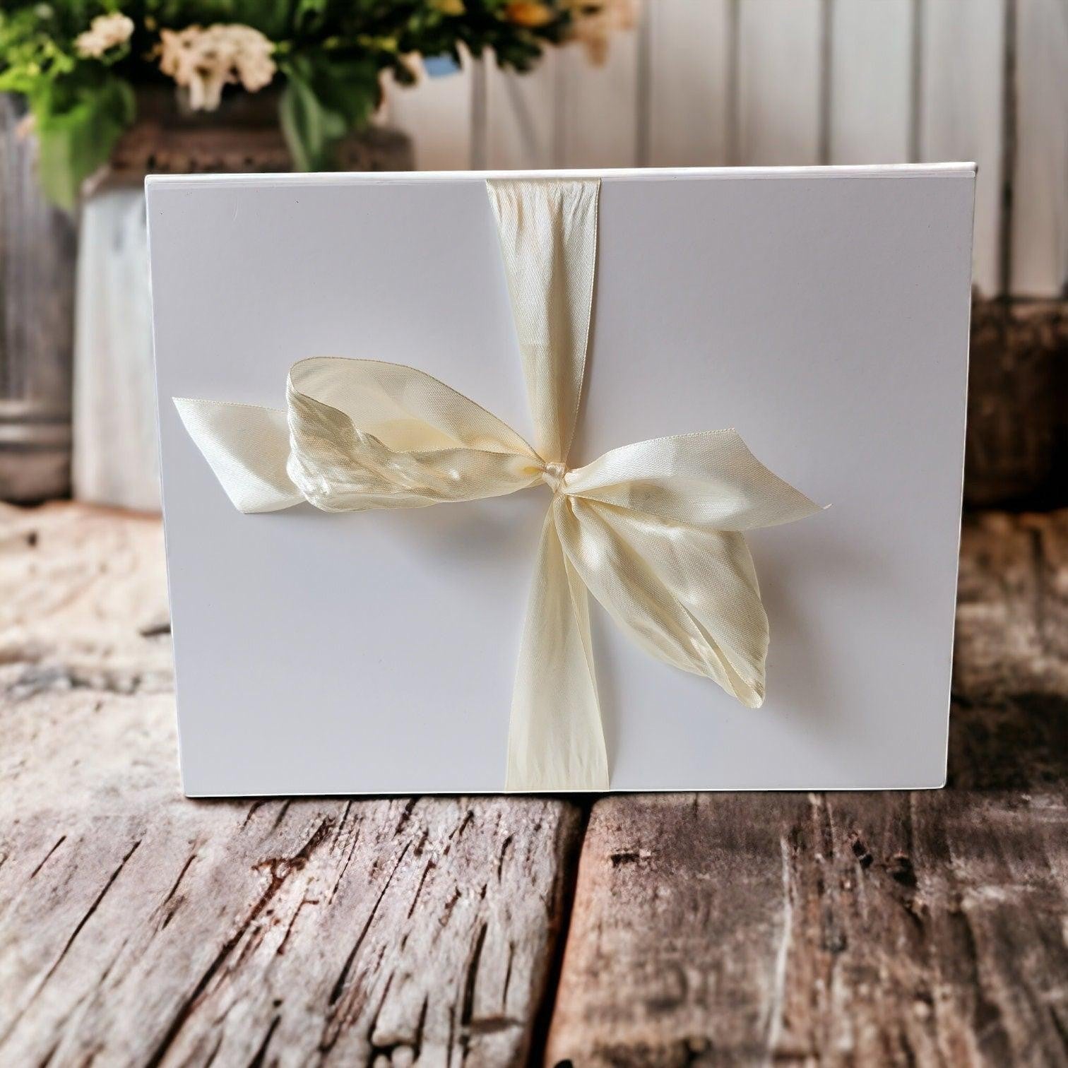 Precious Days Gifts white gift box with cream ribbon bow, perfect for new baby gifts.