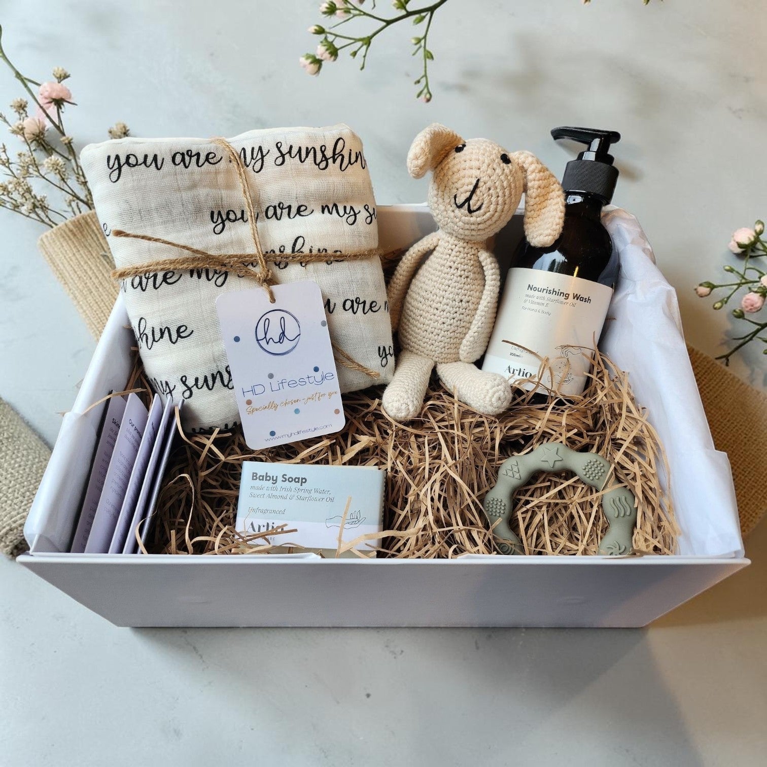 Precious Days Gifts large baby gift box with 'you are my sunshine' muslin, bunny rattle, grey teether, and baby wash.