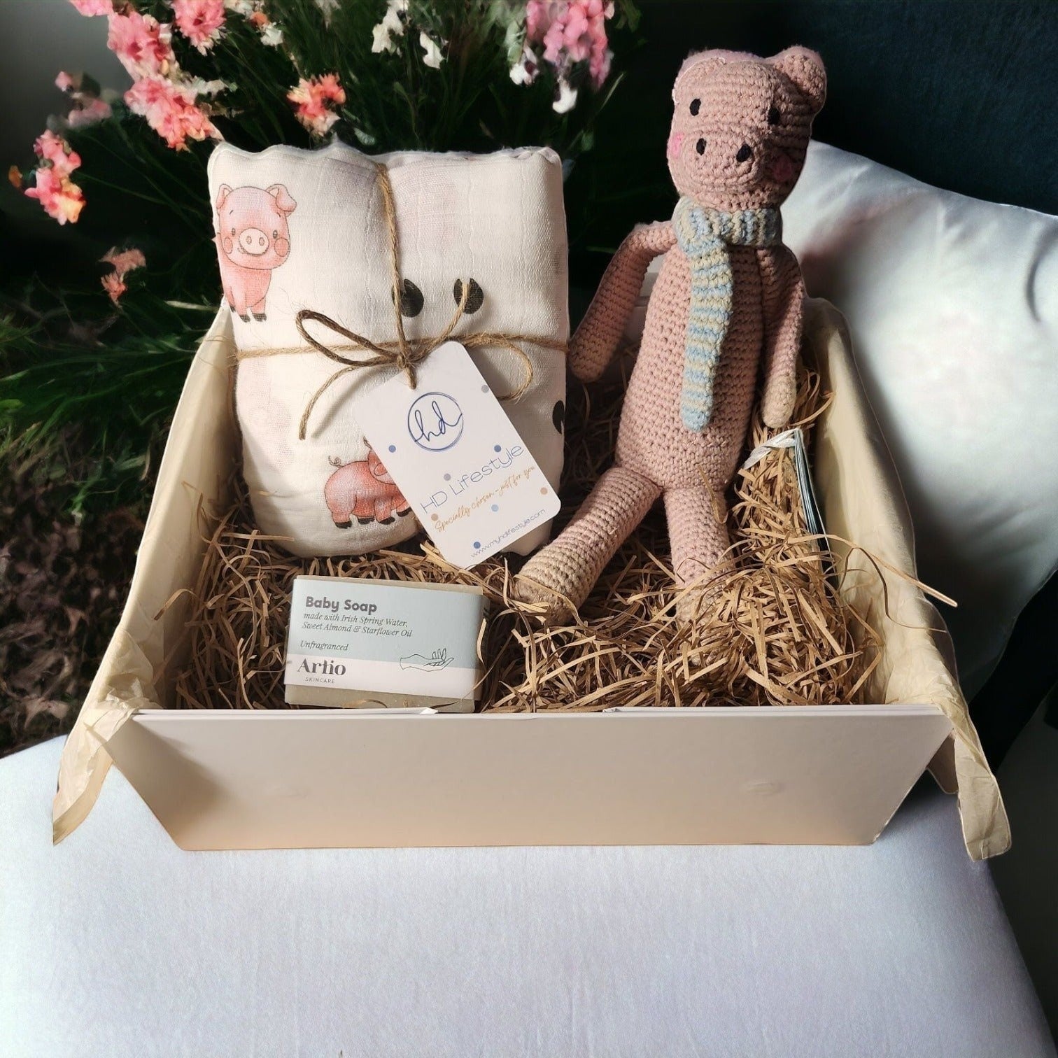 Precious Days Gifts new baby gift box with a pig-themed muslin, pig rattle, and baby soap.