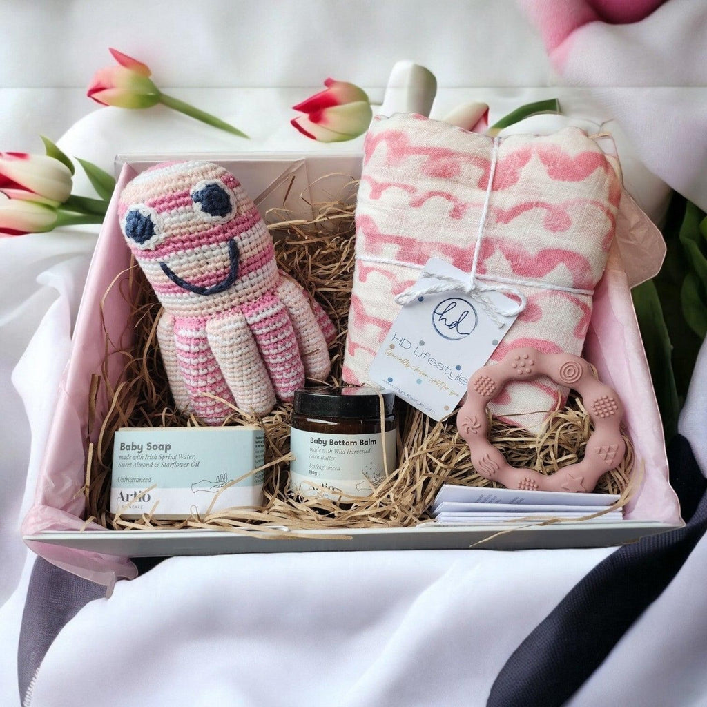 Precious Days Gifts new baby gift box with pink waves muslin, octopus rattle, teether, baby soap and balm.