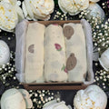 Precious Days Gifts baby muslin set featuring three cotton cloths with rainbow, strawberry, and bear prints in a box