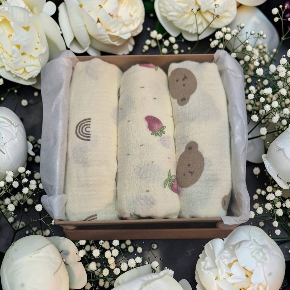 Precious Days Gifts baby muslin set featuring three cotton cloths with rainbow, strawberry, and bear prints in a box
