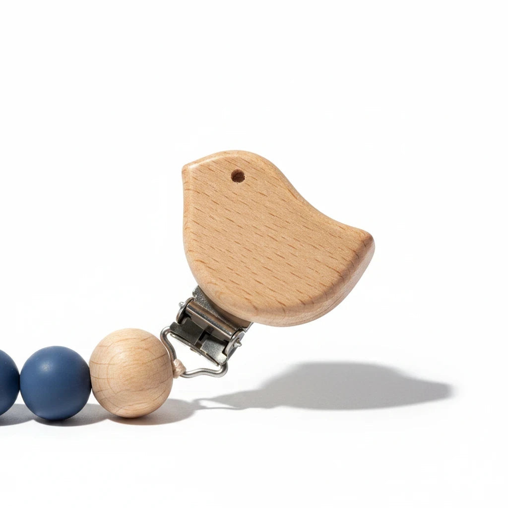 Precious Days Gifts blue bird dummy clip with natural wooden and blue silicone beads on a white background