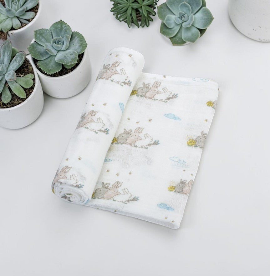 Precious Days Gifts large white cotton muslin swaddle featuring a cute bunny and cloud print pattern