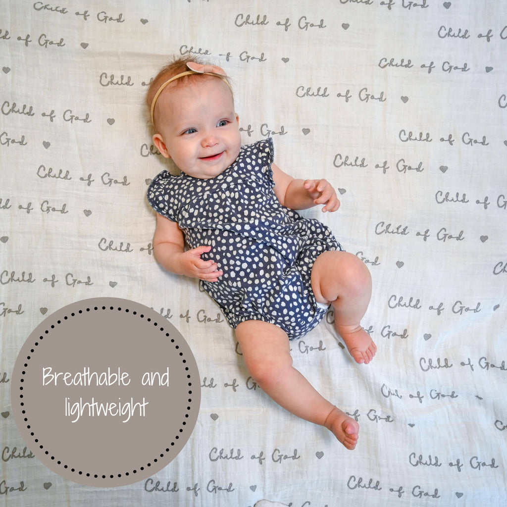 Precious Days Gifts baby lying on a white Child of God muslin swaddle blanket with a breathable cotton texture.