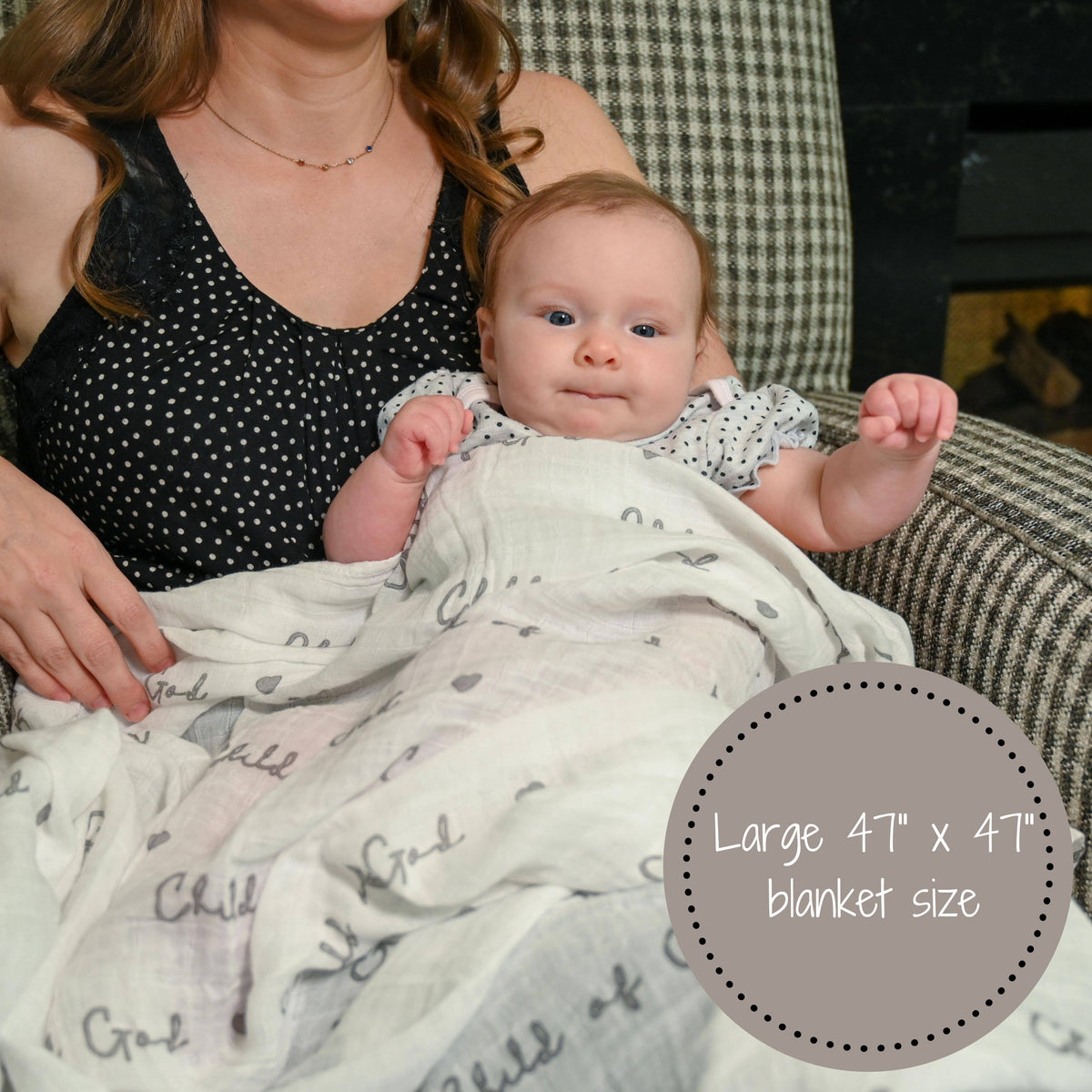 Precious Days Gifts Child of God muslin swaddle blanket covering a baby held by a woman in a patterned armchair