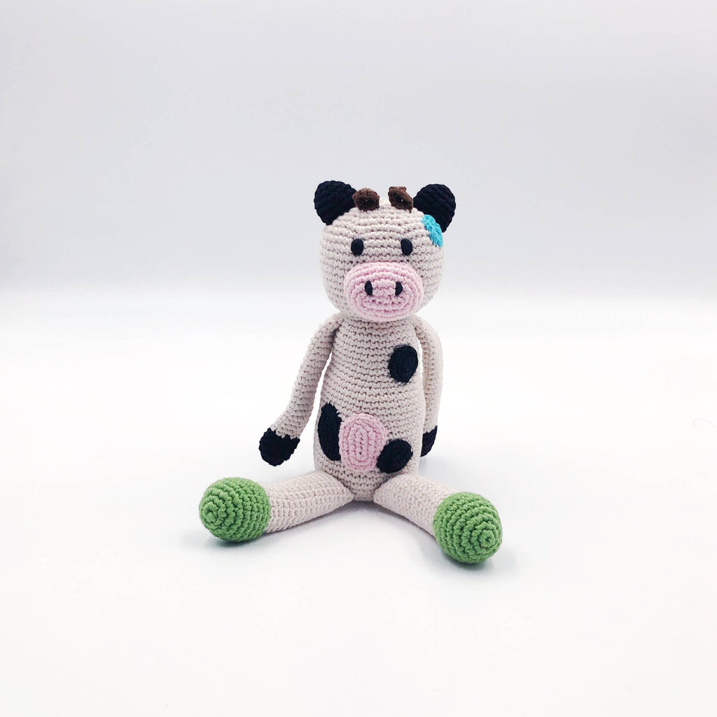 Precious Days Gifts handmade organic cotton plush cow toy with pink nose, black spots, and green feet.