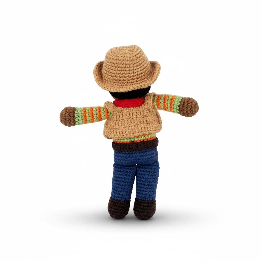 Precious Days Gifts handmade cotton cowboy rattle toy seen from the back with a tan hat and blue trousers