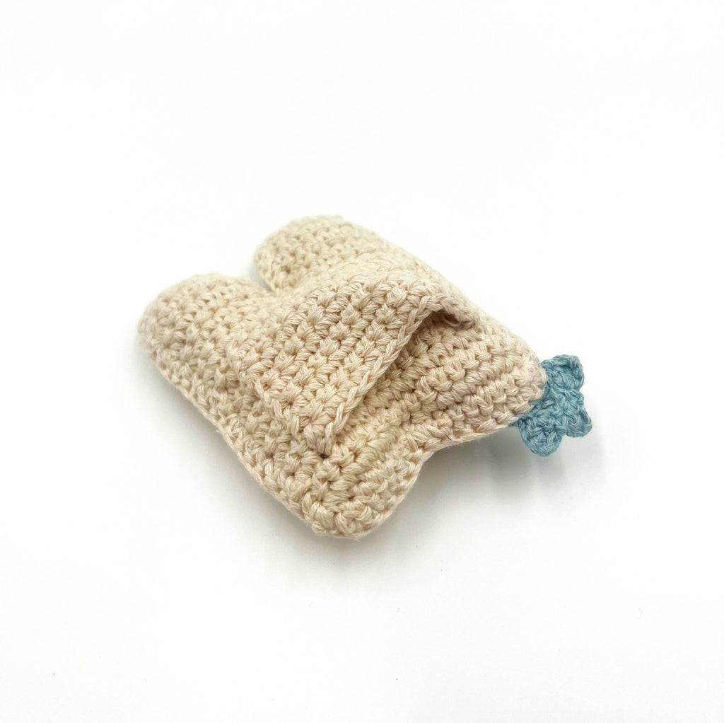 Precious Days Gifts handmade crochet plush tooth with a small pocket and blue detail. Made from fair trade cotton.