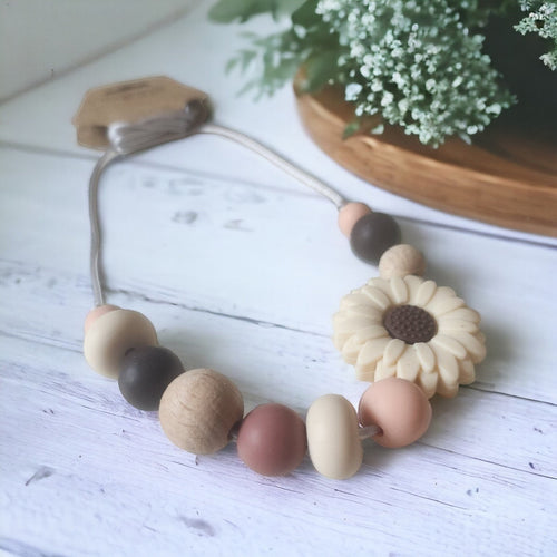 Precious Days Gifts handmade daisy teething necklace with silicone and wood beads in neutral tones.
