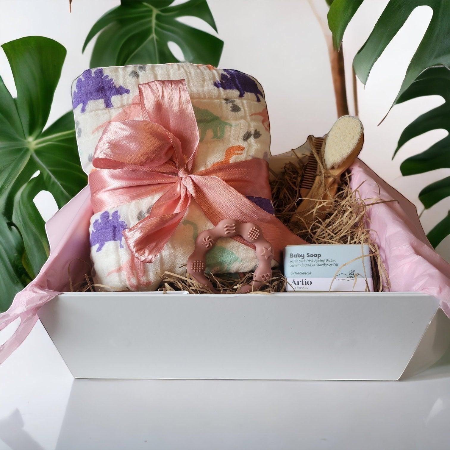 Precious Days Gifts Dinosaur Dreams gift box with a 120cm cotton muslin blanket, teether, baby soap, and brush.
