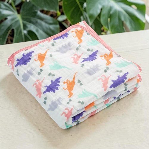Precious Days Gifts Dinosaur Dreams 120cm x 120cm 6-layer cotton muslin blanket with pink trim. Features colorful dinosaur print.