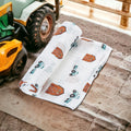 Precious Days Gifts cotton muslin swaddle blanket with farm tractor and barn print, 120x120cm, soft and breathable.