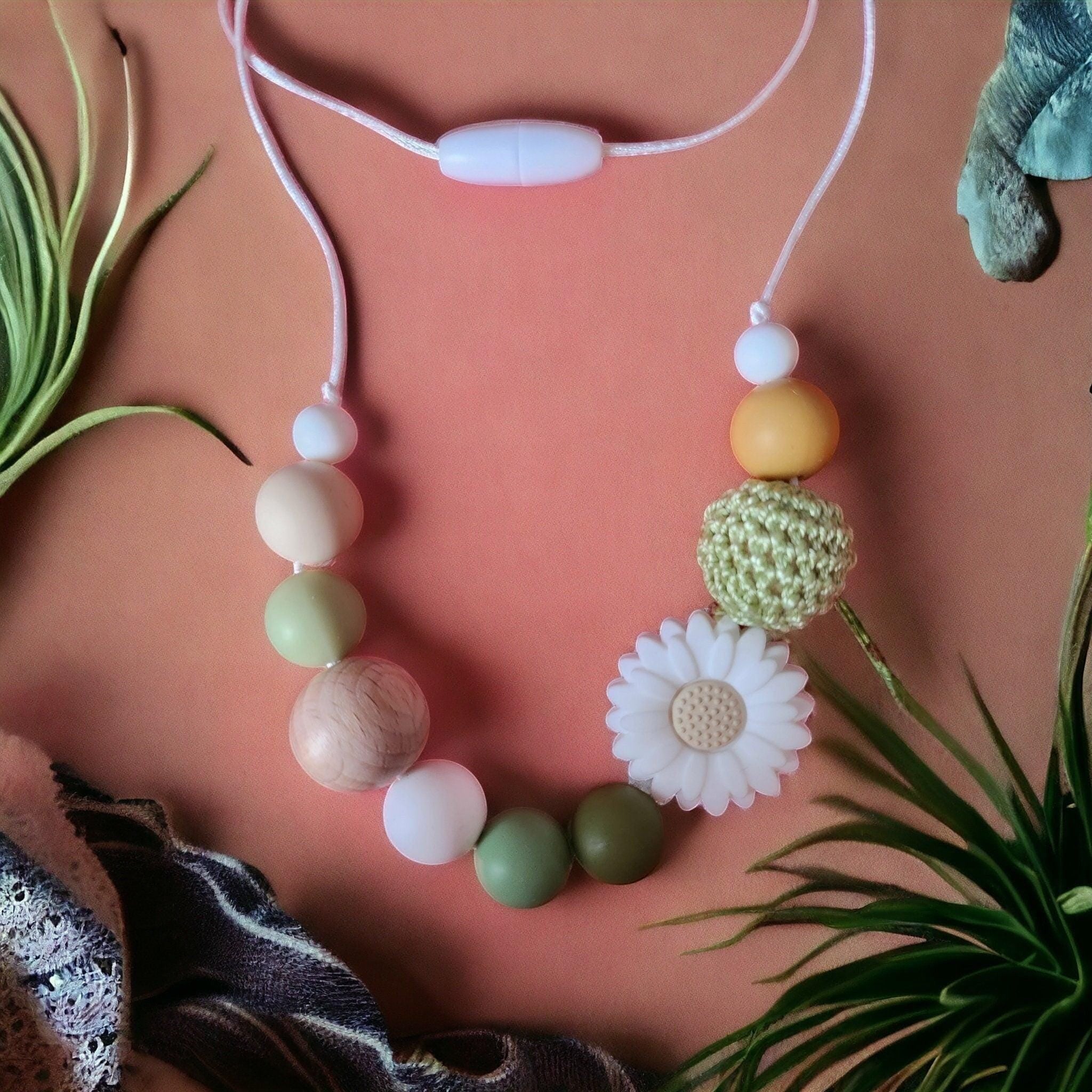 Precious Days Gifts handmade necklace with silicone, wood beads, and a daisy charm in pastel green, cream, and yellow.