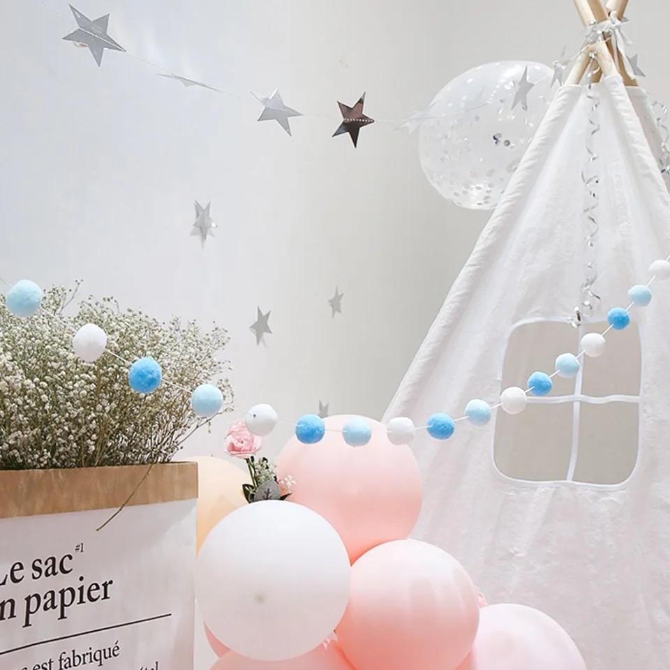 Precious Days Gifts DIY felt ball garland kit with blue and white pom poms, stars, and balloons.