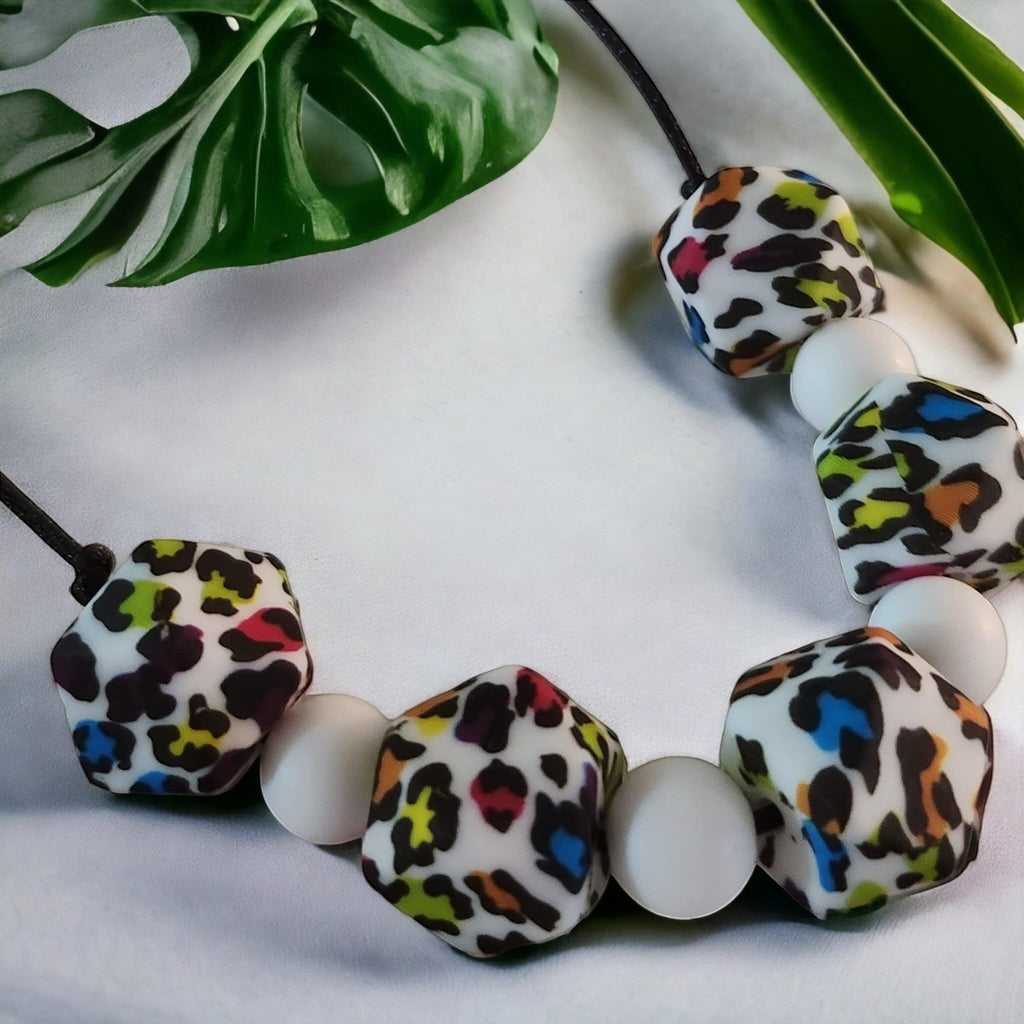 Precious Days Gifts Fierce silicone teething necklace with white and rainbow leopard print beads.