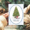 Precious Days Gifts A6 card featuring a traditional Christmas tree, teddy bear, and toy train on a blue striped background