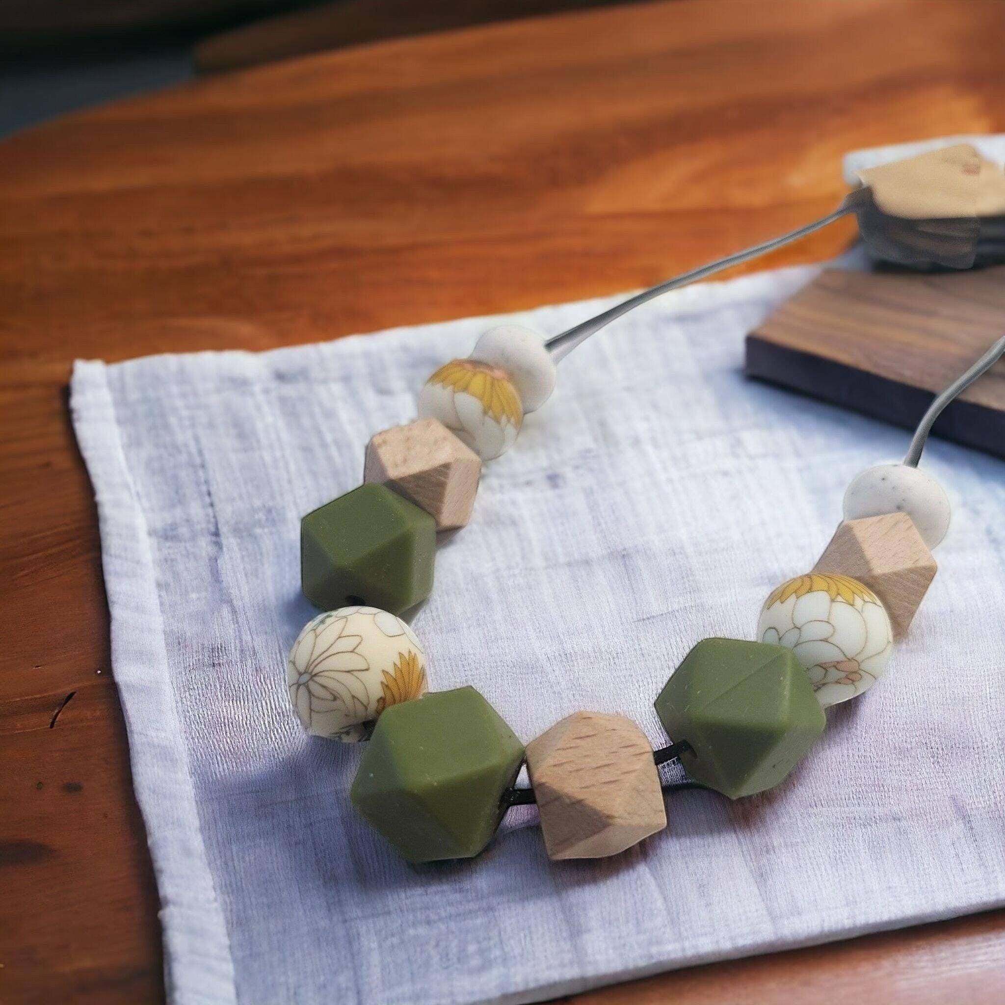 Precious Days Gifts handmade garden-themed teething necklace with silicone, wood, and floral beads.
