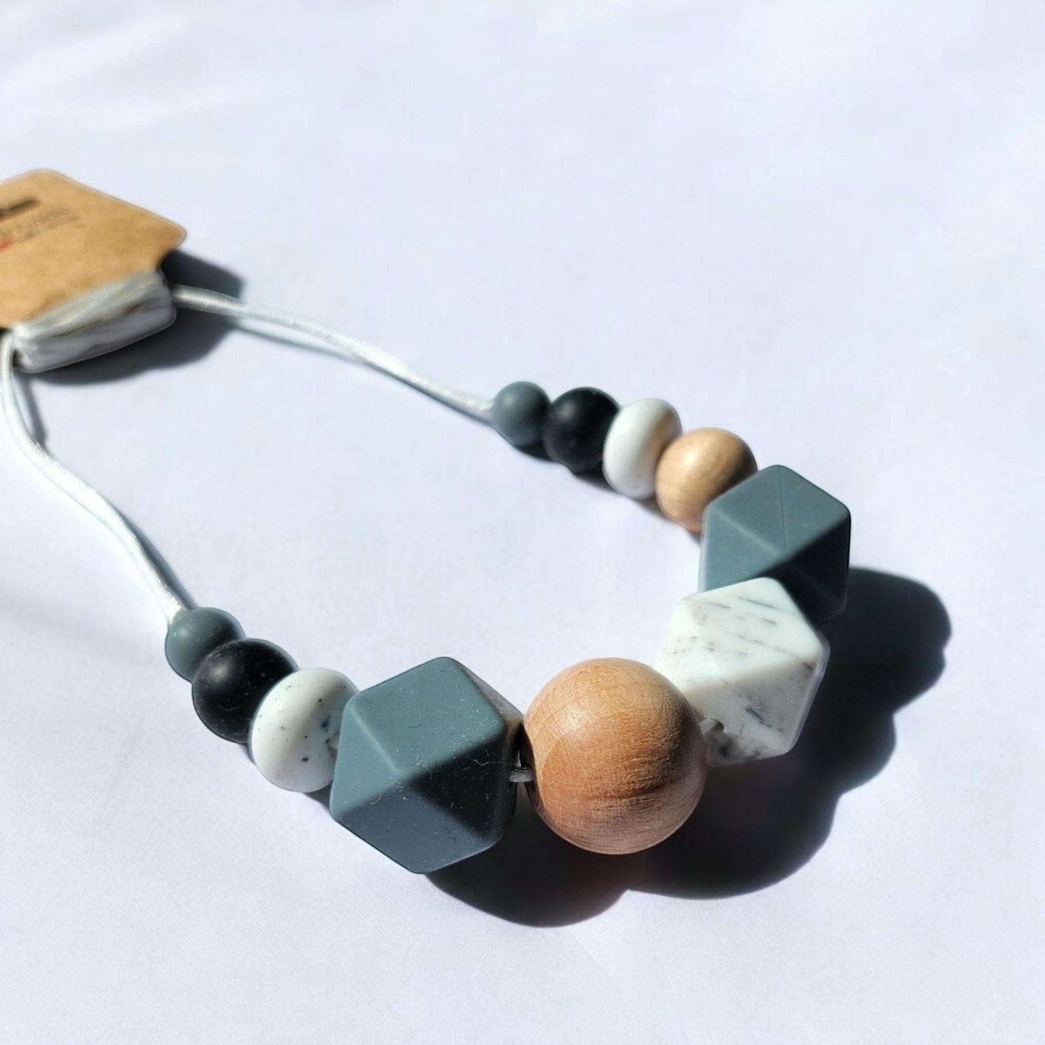 Precious Days Gifts grey mist silicone and wood teething necklace with geometric beads.