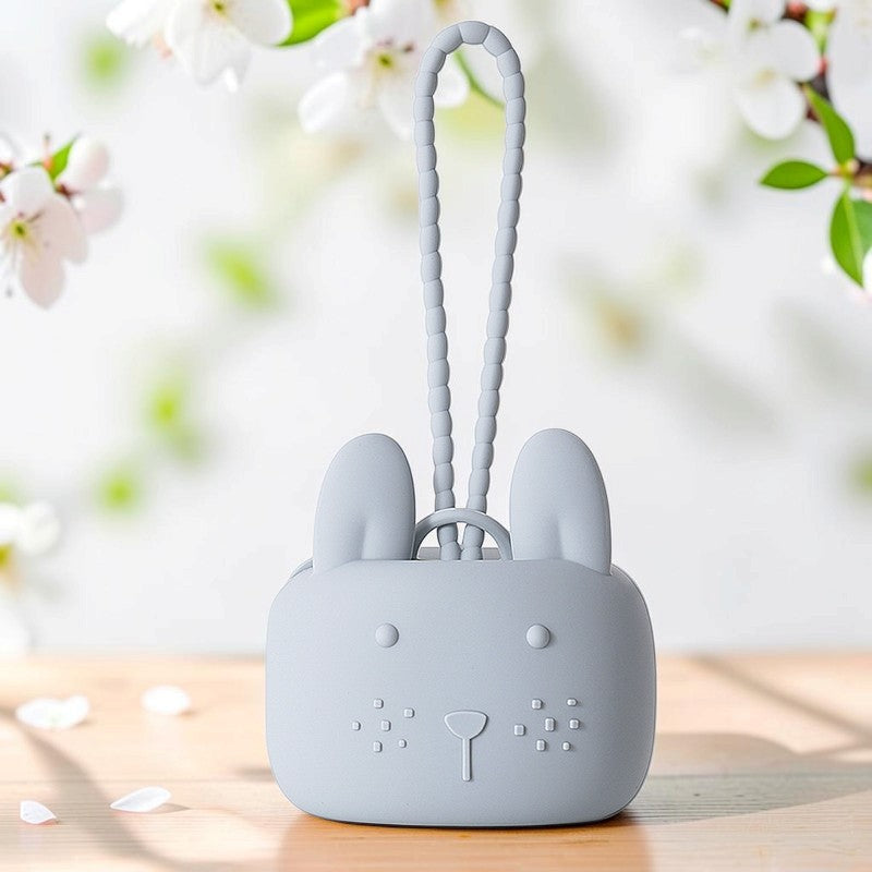 Precious Days Gifts grey silicone bunny storage pouch with a textured wrist strap on a wooden surface