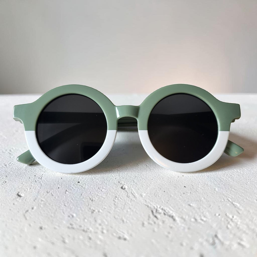 Precious Days Gifts two-tone round frame sunglasses for kids in sage green and white with black lenses.