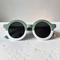 Precious Days Gifts two-tone round frame sunglasses for kids in sage green and white with black lenses.