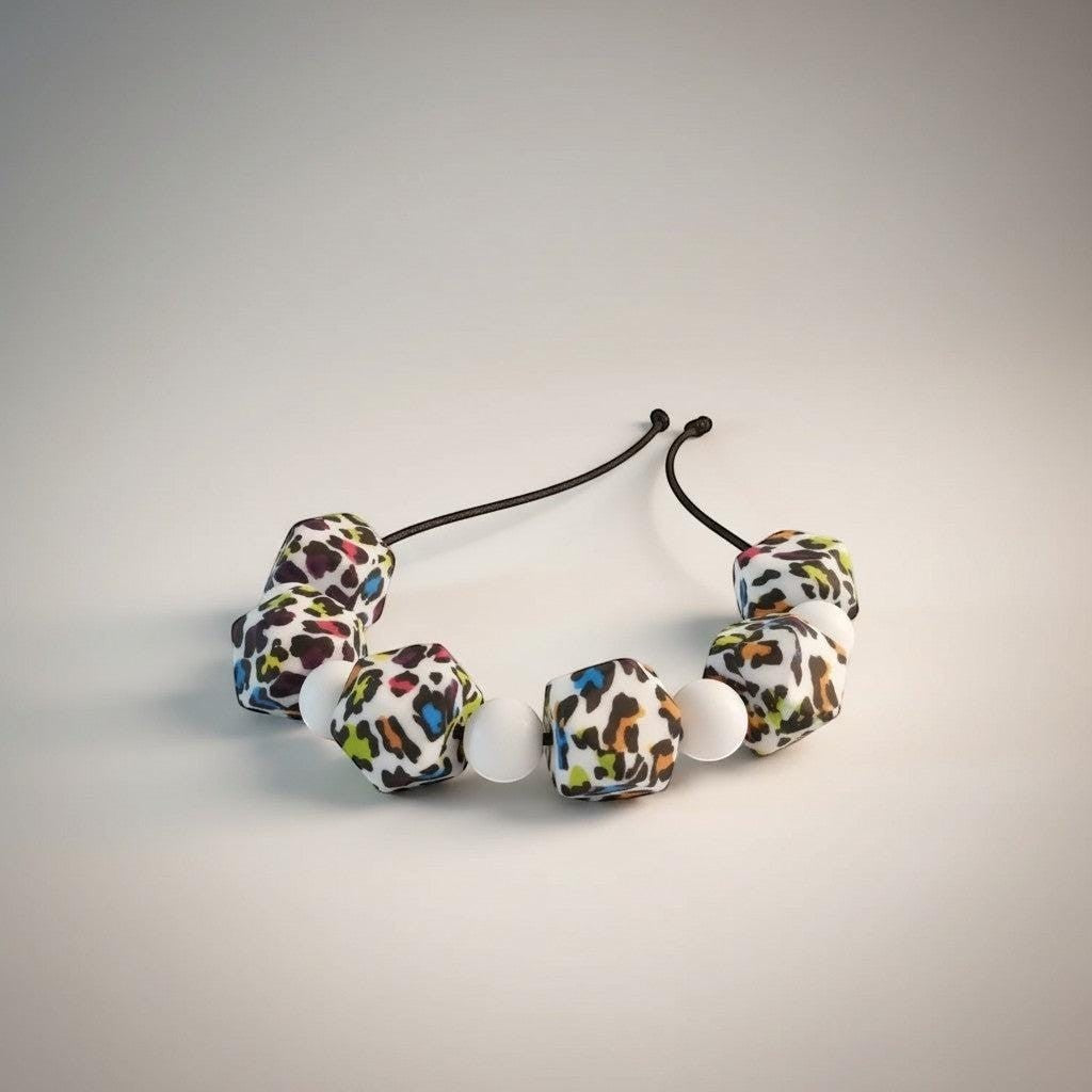 Precious Days Gifts Fierce silicone teething necklace with leopard print and white beads. BPA-free.
