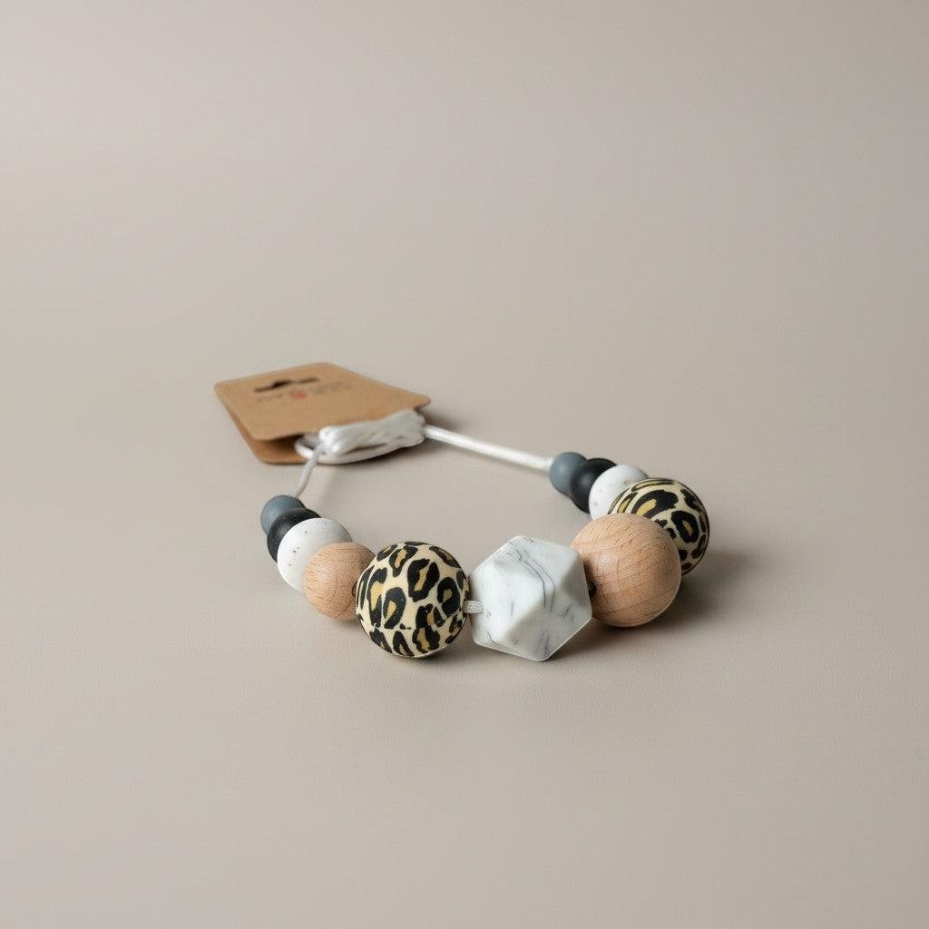 Precious Days Gifts handmade silicone teething necklace with leopard print, wood, marble, and grey beads.