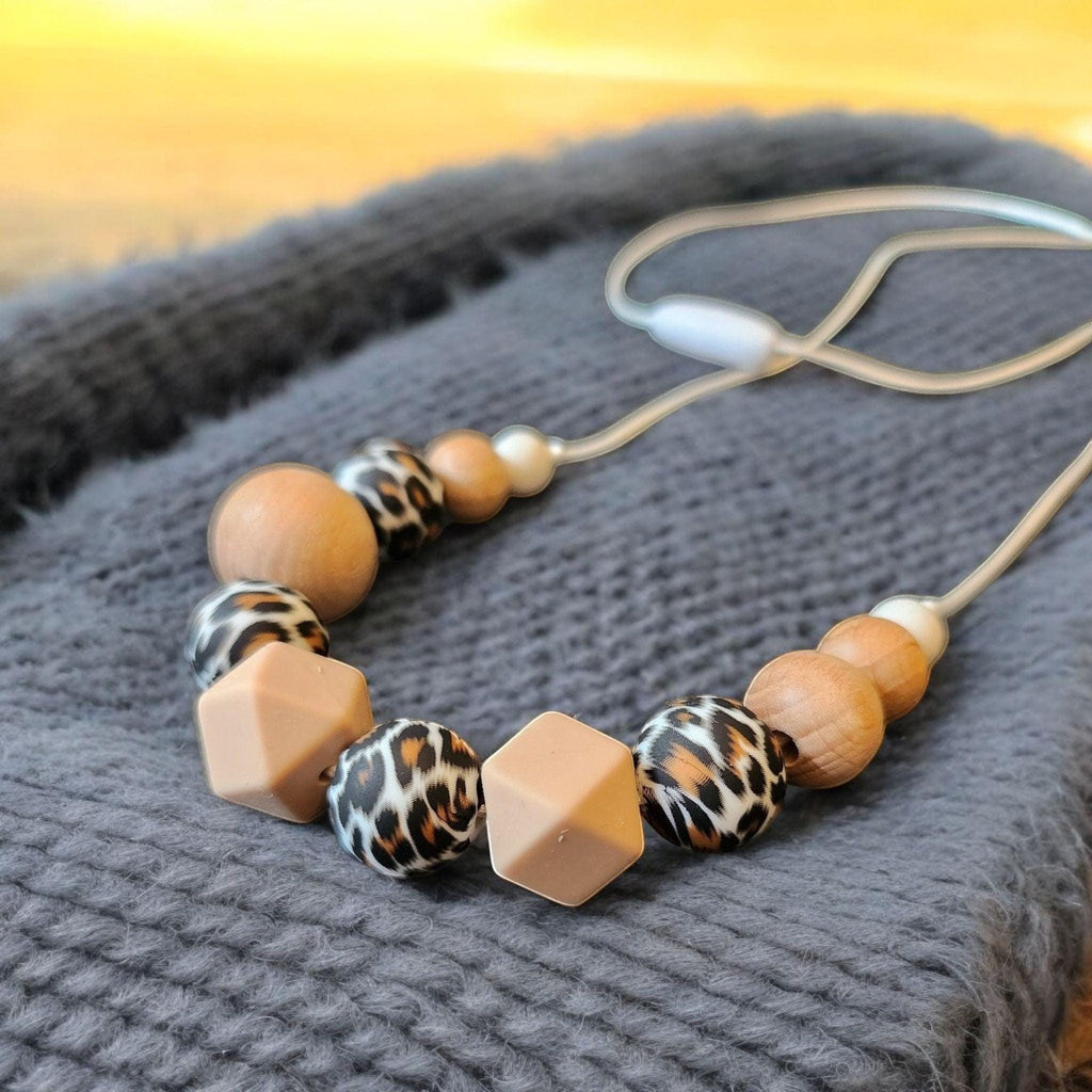 Precious Days Gifts handmade silicone and wood teething necklace with leopard print and geometric beads.