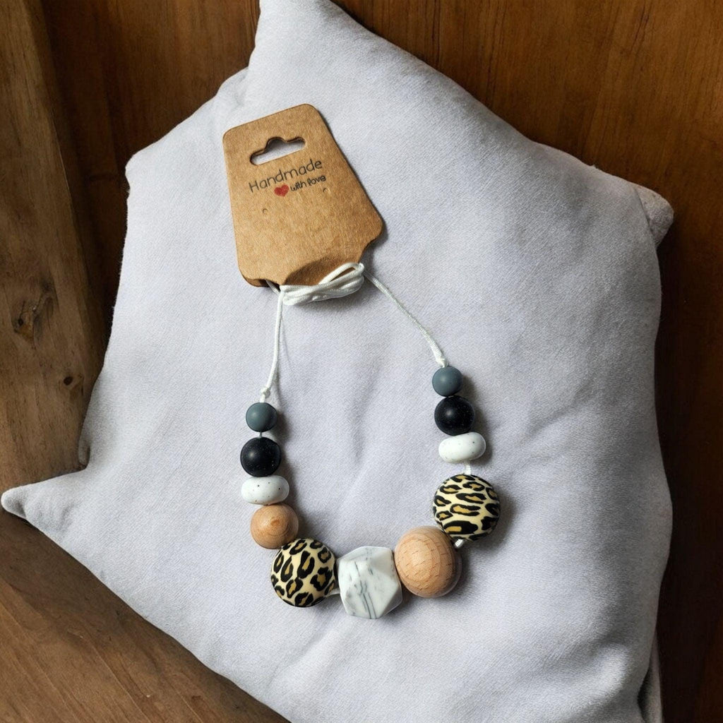 Precious Days Gifts handmade silicone and wood teething necklace with leopard print, black, white, grey, and marble beads.