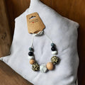 Precious Days Gifts handmade silicone and wood teething necklace with leopard print, black, white, grey, and marble beads.