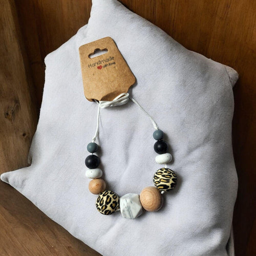Precious Days Gifts handmade silicone and wood teething necklace with leopard print, black, white, grey, and marble beads.