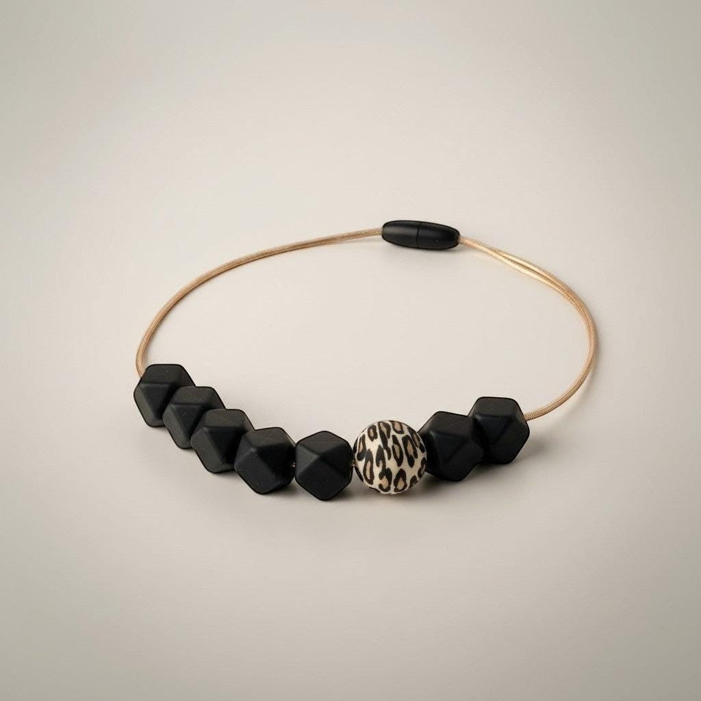 Precious Days Gifts Midnight Leopard silicone teething necklace with black geometric beads and a leopard print focal bead.