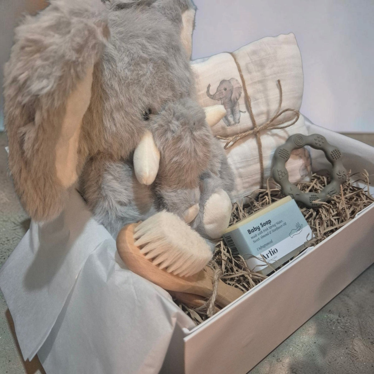 Precious Days Gifts luxury new baby box featuring a plush elephant toy, muslin cloth, soap, brush, and silicone teether