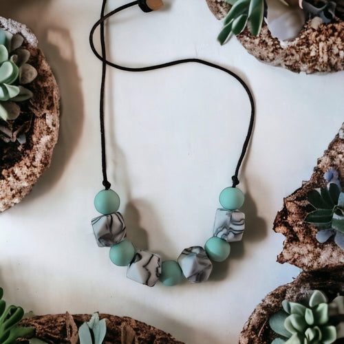 Precious Days Gifts mint marble silicone teething necklace with cube and round beads. BPA-free, food-grade.