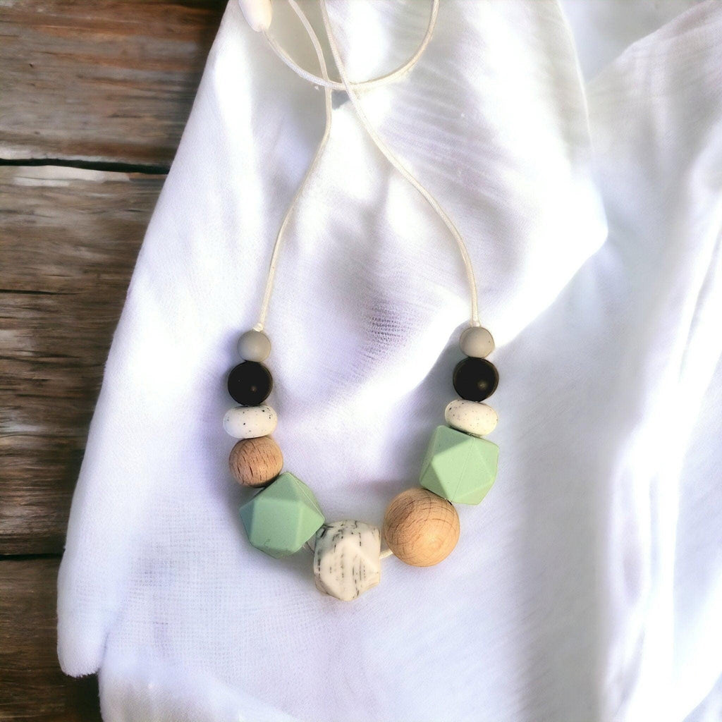 Precious Days Gifts mint green silicone and wood teething necklace with speckled and black beads
