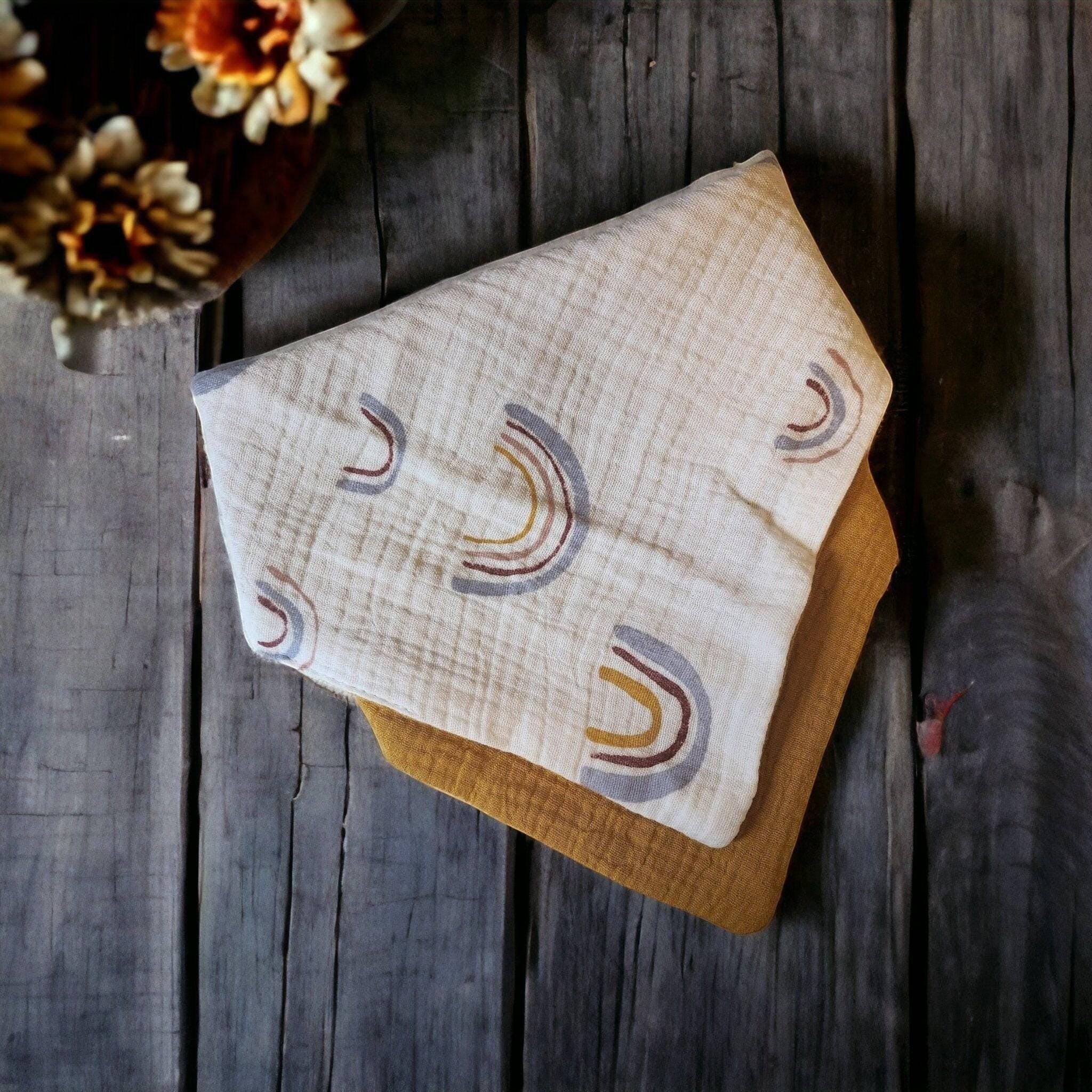 Precious Days Gifts soft muslin baby bibs with rainbow pattern, made from breathable cotton. Mustard yellow backing.