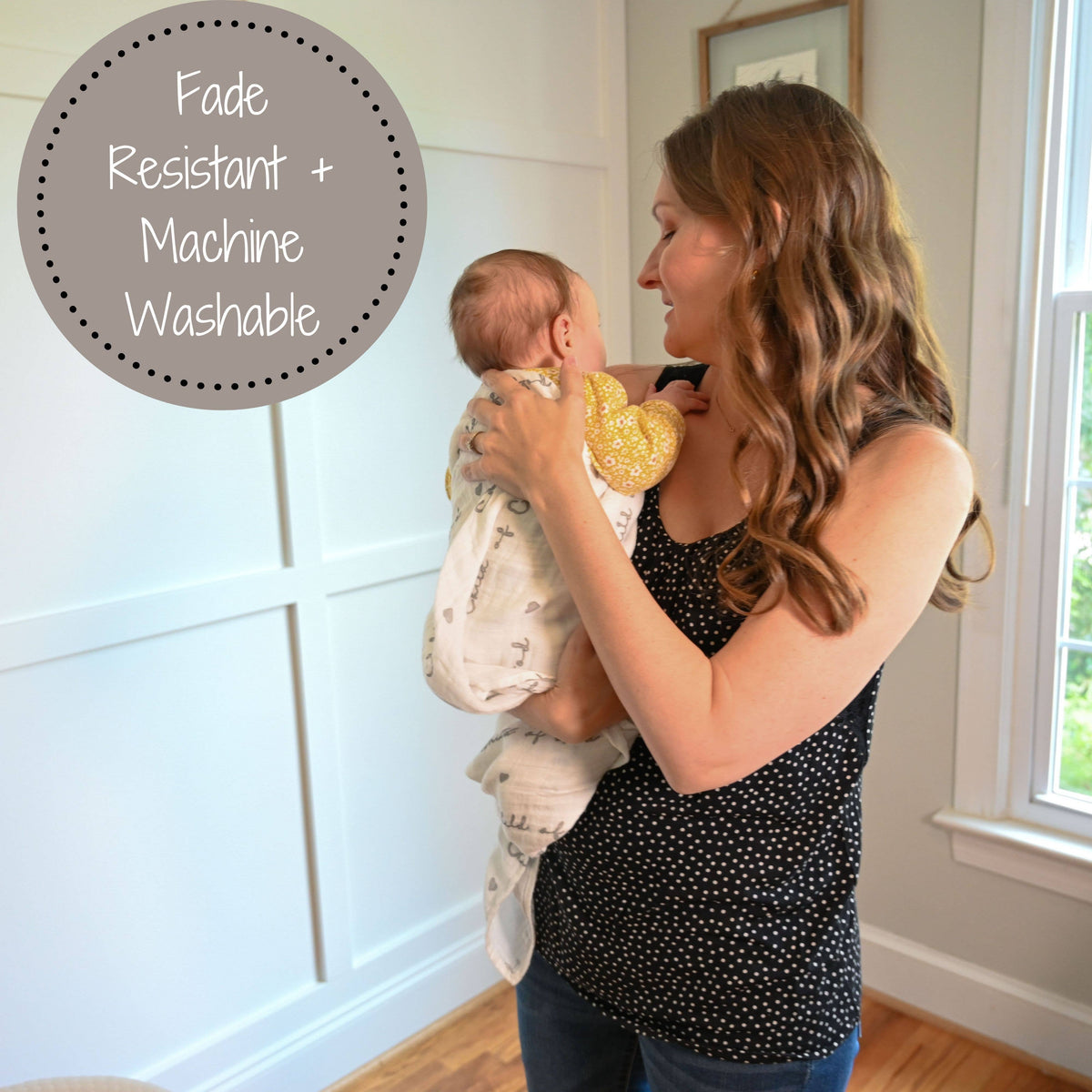 Precious Days Gifts muslin swaddle blanket with Child of God print being used by a mother holding her baby