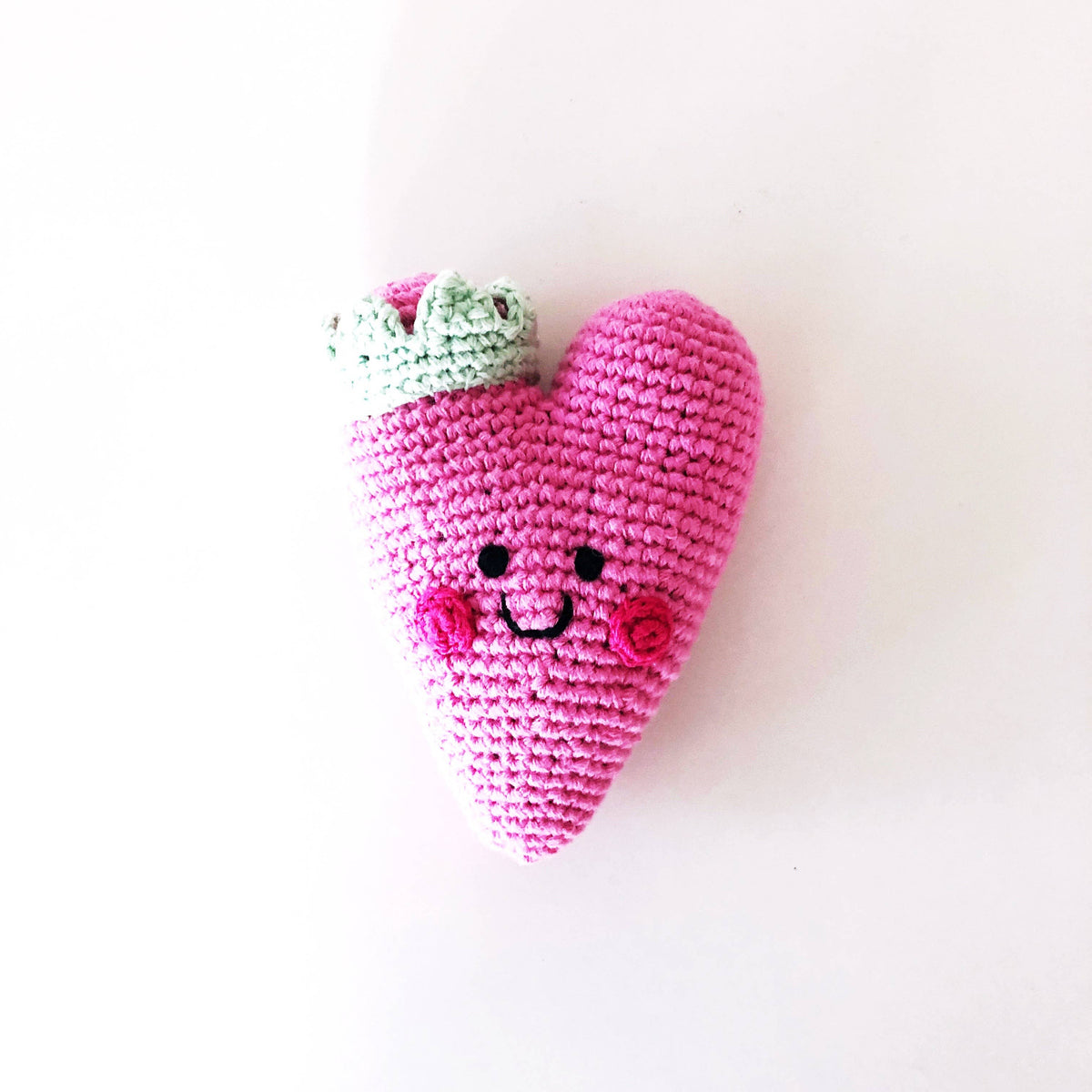 Precious Days Gifts pink heart-shaped crochet baby rattle with a smiling face and mint green leaf detail
