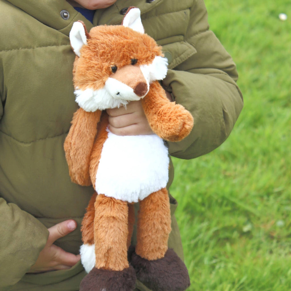Precious Days Gifts soft plush fox toy with orange fur and white belly held by a child in a green jacket