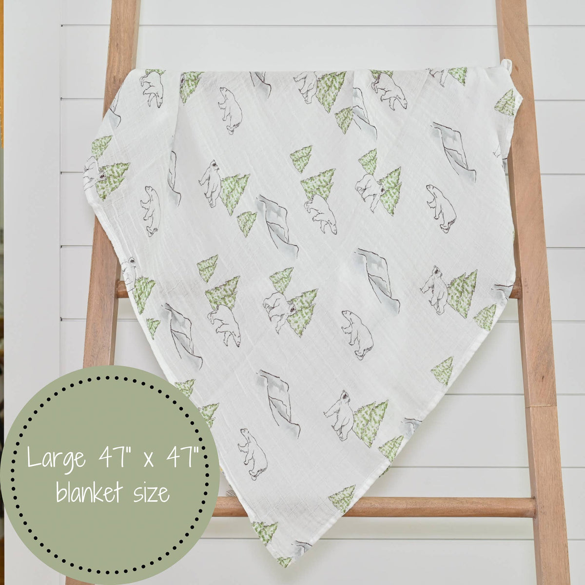 Precious Days Gifts muslin swaddle blanket featuring a polar bear and pine tree print on a white cotton fabric.
