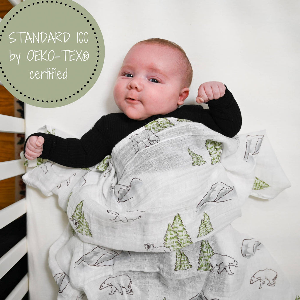 Precious Days Gifts baby swaddled in a white cotton muslin blanket with a polar bear and pine tree print