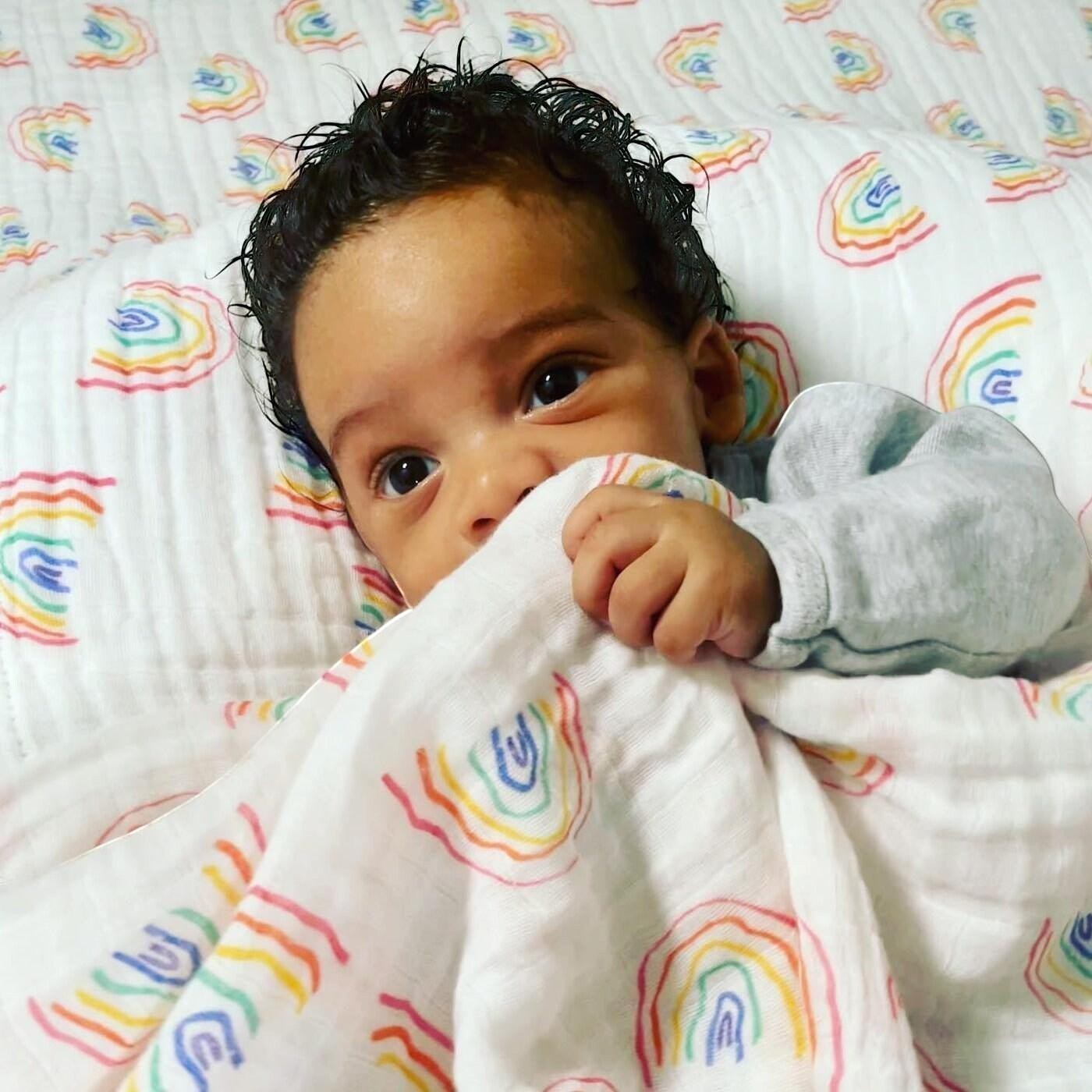 Precious Days Gifts rainbow print 6-layer cotton muslin blanket with baby.