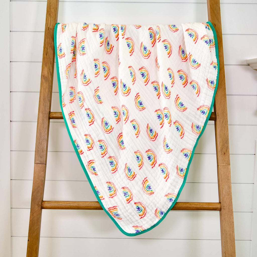Precious Days Gifts 6-layer 100% cotton muslin quilt with a hand-drawn rainbow pattern and teal trim. 120x120cm.